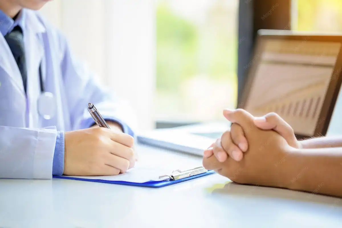 Doctor reviewing a patient's intake form at the consultation desk